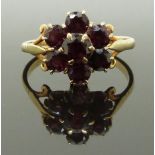 A 9ct gold cluster ring set with a cluster of garnets, size R, 3.00g