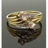A 9ct gold ring set with two pear cut morganite and diamonds, size M/N, 1.84g