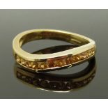 A 9ct gold ring set with yellow sapphires, size N, 2.82g