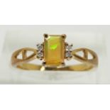 A 9ct gold ring set with an emerald cut opal and diamonds, 1.8g, size N