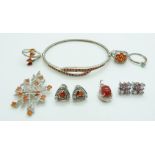 A collection of silver jewellery to include a bangle set with fire opals, pendant set with fire
