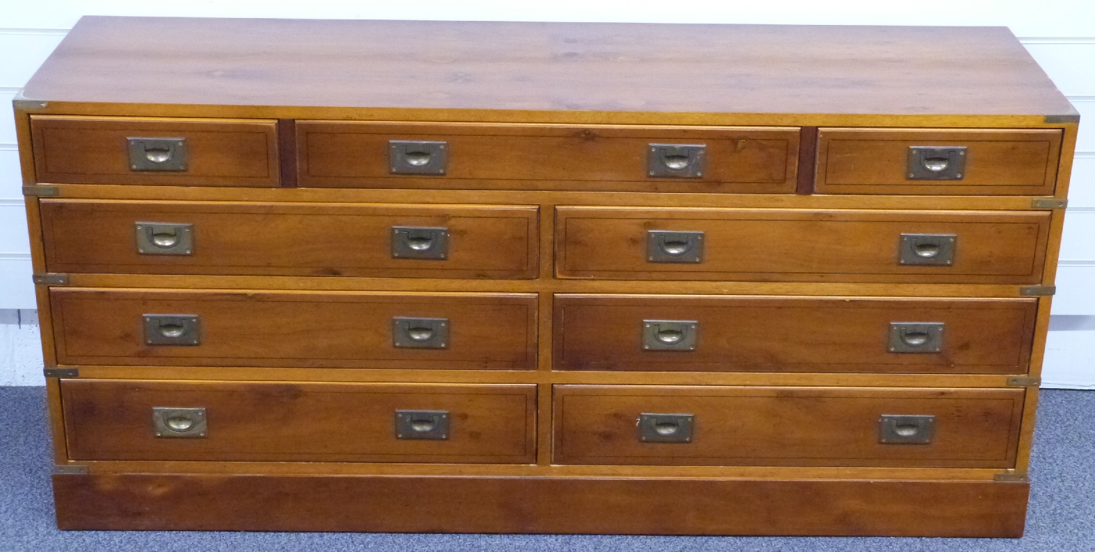 Large campaign style chest of three over six drawers with brass handles, W147 x D43 x H71cm