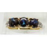 A 9ct gold ring set with three round boulder opal cabochons and white sapphires, 2.3g, size N