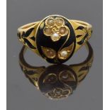 Victorian mourning ring set with seed pearls in the form of a flower on black enamel ground, with