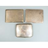 Three hallmarked silver cigarette cases including an Art Deco example, weight 438g all in