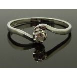 A 9ct white gold ring set with a diamond in a twist setting, size P/Q, 1.72g