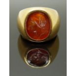 A yellow metal ring set with a carnelian agate intaglio, size M/N, 18.10g