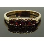 A 9ct gold ring set with garnets, size Q/R, 2.32g