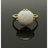 A yellow metal ring set with a round opal cabochon, 2g, size H/I