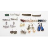 A collection of silver earrings including pearl and cubic zirconia