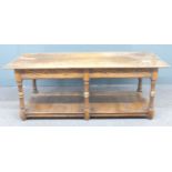 An oak coffee table with carved decoration to the sides and legs, W122 x D54 x H46cm