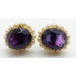 A pair of 9ct gold earrings set with an oval cut amethyst surrounded by seed pearls, 4.7g