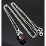 An 18ct white gold pendant set with an oval cut ruby measuring approximately 1.8ct, a square cut