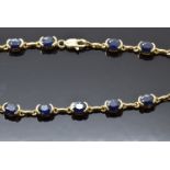 A 9ct gold bracelet set with oval sapphires, 7.8g