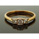 A yellow metal ring set with three diamonds in square settings, size L/M, 1.83g