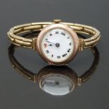 Swiss 9ct gold ladies wristwatch with blued hands, black Roman numerals, white enamel dial, gilt