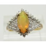 A 9ct gold ring set with a marquise cut Indonesian opal and zircons, 3g, size S