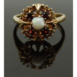 A 9ct gold ring set with an opal and garnets, size L, 2.72g