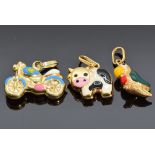 Three 9ct gold and enamel charms, one in the form of a cow, one a parrot and the other a
