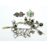 A silver/ white metal charm bracelet, continental silver brooch set with paste and a Victorian