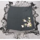 A 19th/20thC Chinese black shawl with embroidered floral decoration and fringe, 180 x 180cm