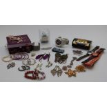 A collection of costume jewellery including amethyst, beaded necklaces, vintage brooches, etc