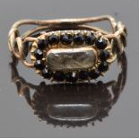 Georgian mourning ring set with plaited hair in a glass compartment surrounded by French jet, size