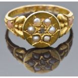 Victorian 15ct gold ring set with a diamond surrounded by seed pearls, the shoulders set with