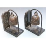 A pair of Art Deco style marble bookends with hanging Tibetan bells, height 26cm