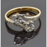 An 18ct gold ring set with two old cut diamonds, each approximately 0.35ct, and with diamond
