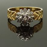 A 9ct gold ring set with a diamonds with textured detail to the shoulders, size M, 2.63g