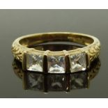A 9ct gold ring set with three square cut paste, size N, 2.23g