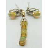 A 9ct gold pendant set with three oval Indonesian opals, with a pair of similar earrings