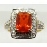 A 9ct gold ring set with a cushion cut Salamanca fire opal and diamonds, 4g, size M