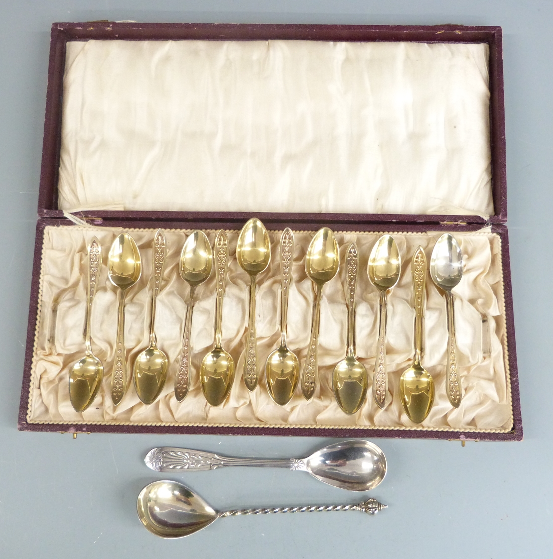 Cased set of 12 gilt metal spoons and two Swedish silver spoons, weight 43g