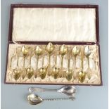 Cased set of 12 gilt metal spoons and two Swedish silver spoons, weight 43g