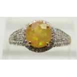 A 9ct gold ring set with a round cut Indonesian opal and zircons, 2.8g, size S