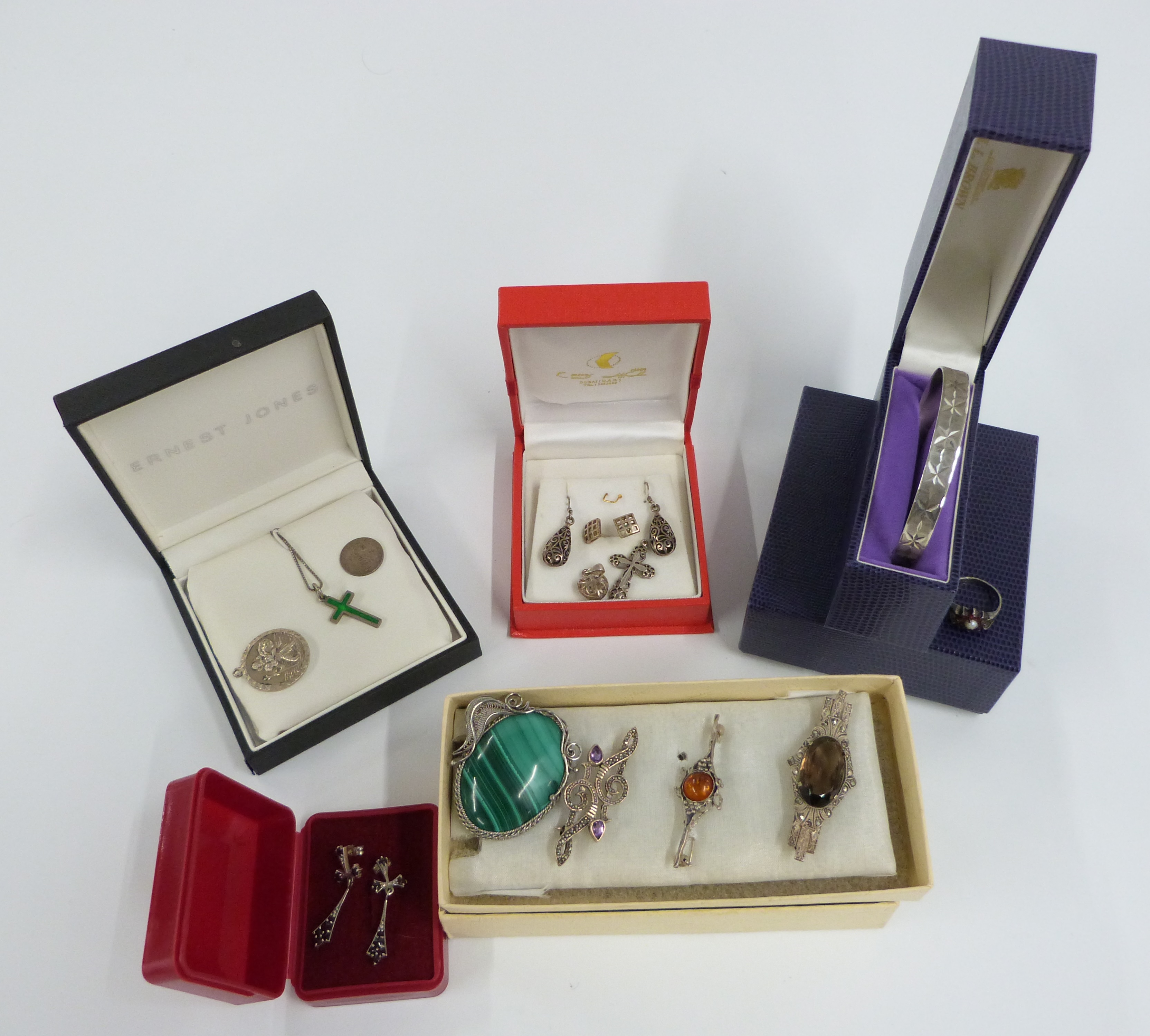 A collection of silver jewellery including malachite, pressed amber and quartz brooches, earrings,