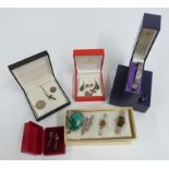 A collection of silver jewellery including malachite, pressed amber and quartz brooches, earrings,