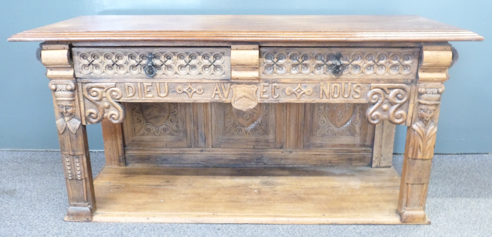 French 19th/20thC oak low table with two drawers, undershelf and carved figural decoration either