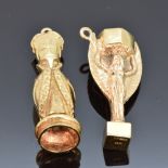 A 9ct gold charm in the form of a bishop and a 9ct gold charm in the form of a trophy, 12.8g