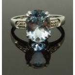 A 9ct white gold ring set with an oval cut aquamarine and diamonds, size J, 2.00g