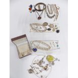 A collection of silver and paste jewellery including ingot, thimble, St Christoper, bangle,