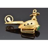 An 18k gold pendant/charm in the form of a helicopter and a hardstone cabochon, 4g