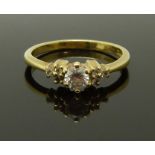 An 18ct gold ring set with a diamond of approximately 0.25ct and further diamonds to the
