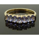 A 14K gold ring set with tanzanites, size P, 2.35g