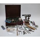 A collection of watch maker's tools, eye glasses etc together with a wooden fitted pocket watch