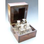 19thC liqeur set or travelling tantalus in fitted rosewood case, with four cut glass decanters and