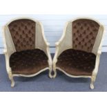 Pair of Continental style bergere armchairs with cream painted frames and button back upholstery.