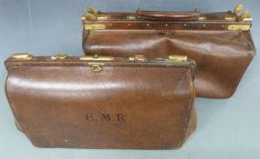 Two vintage brown leather Gladstone bags with brass fittings, largest 22 x 45cm
